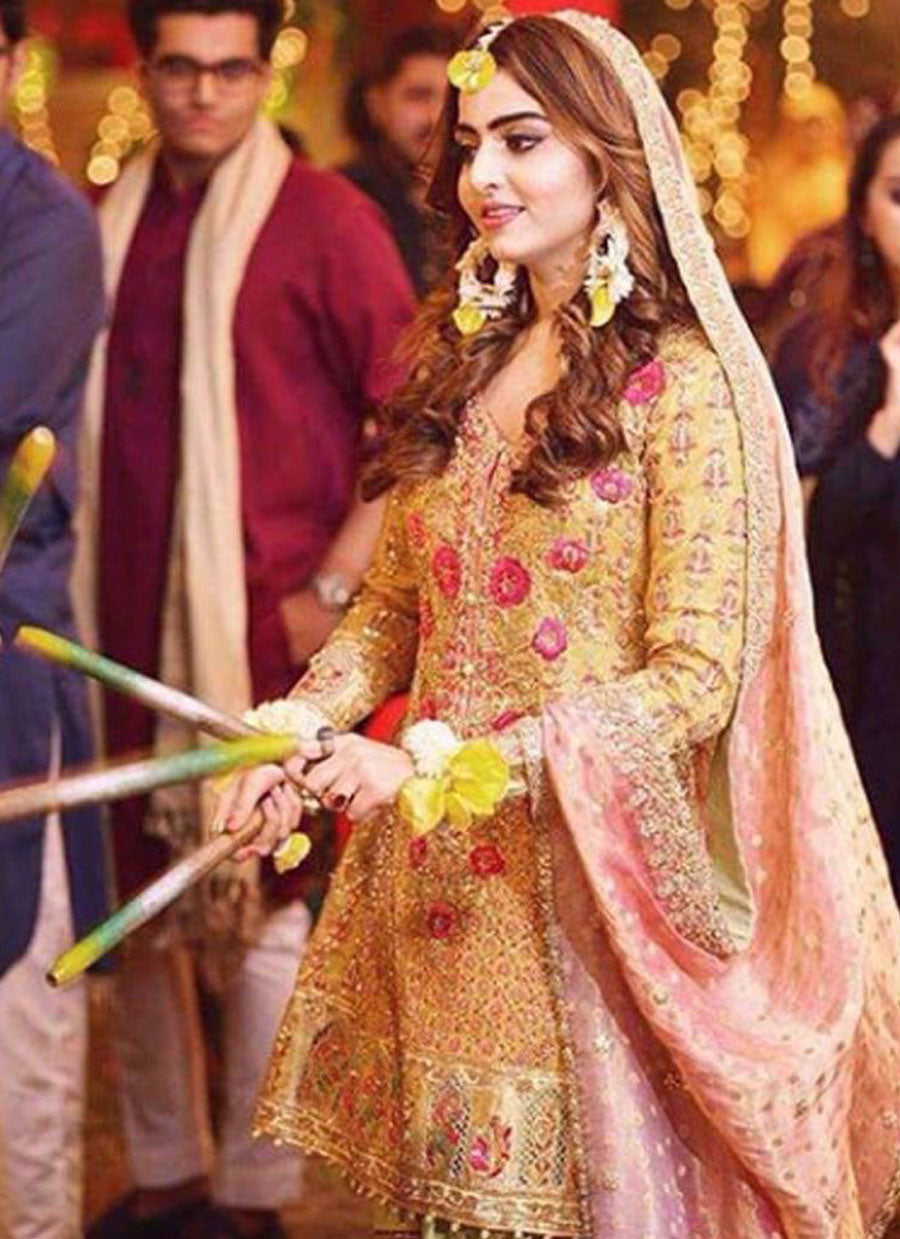 Sara, glowing in a saffron yellow kalidaar paired with a mint gharara