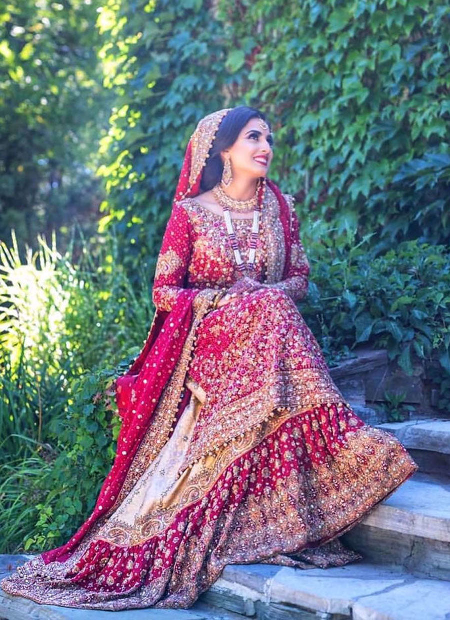 Farah Talib Aziz gives us a masterclass on how to carry the iconic red bridal. Featured here is a traditional scarlett red ensemble with gold embellishments
