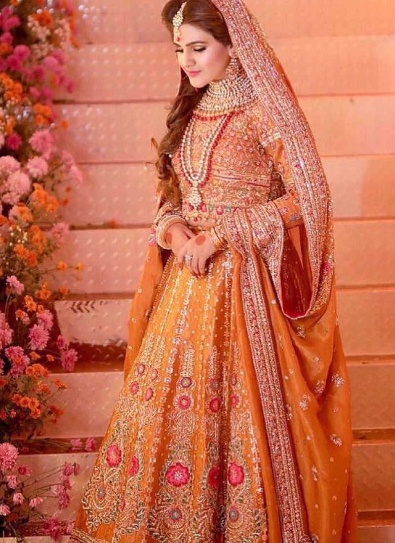 Sijjal Elahi absolutely regal in a burnt orange Farah Talib Aziz lengha choli featuring intricate gold zardozi, French knots and single dhaagha embellishments